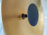 a gold plate with a blue lid sitting on a table