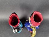two red and blue vases sitting on a table
