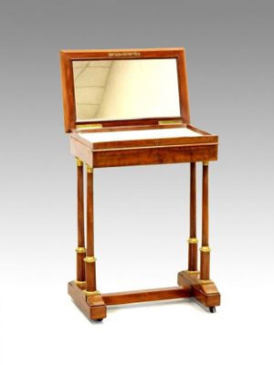 a small wooden desk with a mirror on top of it