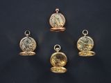 four different types of pocket watches are displayed on a black surface