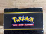 a close up of a box of pokemon cards on a wooden table