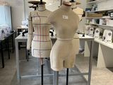 three mannequins on display in a room