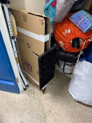 a pile of boxes and bags on the floor next to a blue door