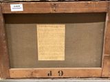 an old picture of a wooden frame with a piece of paper on it