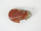 a picture of a red and white stone with a tag on it