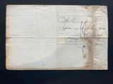 an old piece of paper with writing on it sitting on a table