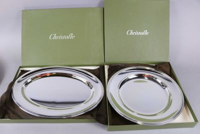 two silver plates in a green box on a white table