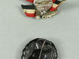 three medals are displayed on a white surface with a red, white, and blue ribbon