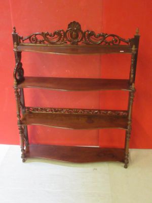 a wooden shelf with three shelves on top of it