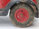 a red toy truck with a black tire and a red wheel