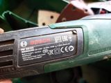 a close up of a person ' s hand holding an electric tool