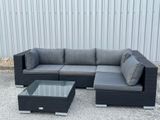 an image of a couch and coffee table in front of a building