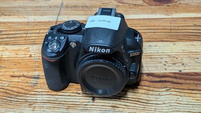 a black camera sitting on a wooden table