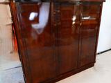 a wooden cabinet with glass doors in a room