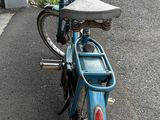 a blue motorcycle parked on the side of the road