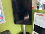 a television that is on a stand in a room