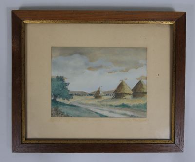 tableau encadré représentant un paysage avec un village au loin