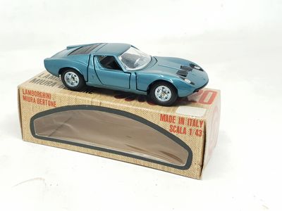 a blue toy car sitting on top of a cardboard box