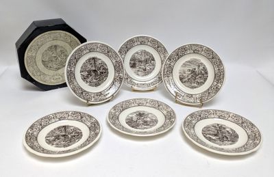 six brown and white plates with black and white designs and a clock