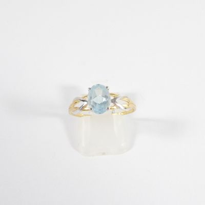 an image of a ring with a blue topaz stone