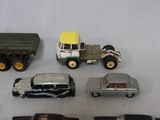 several toy cars and trucks are lined up on a white surface