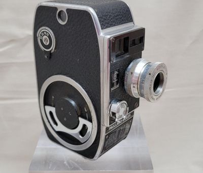 a black and white photo of a camera on a stand