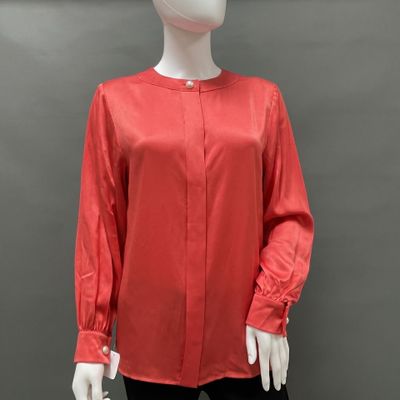 a mannequin mannequin wearing a red blouse and black pants