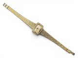 une image d'une montre en or sur fond blanc