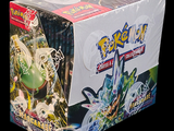 a box of pokemon trading card game items on a black background