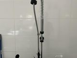 a picture of a kitchen sink with a faucet and soap dispenser