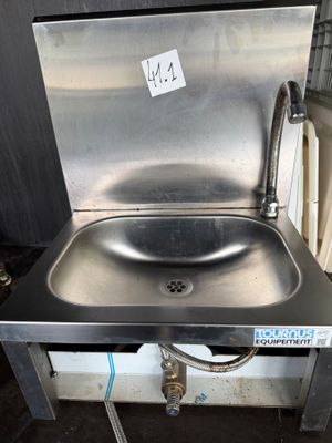 a stainless steel sink with a faucet on the side of it
