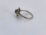 a close up of a silver ring on a white surface