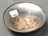 a metal bowl with a small amount of food in it