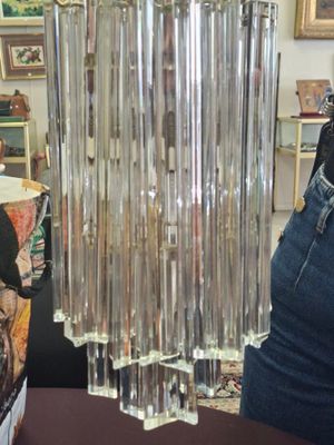 a glass chandelier hanging from the ceiling in a room
