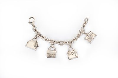 a close up of a silver bracelet with charms on it