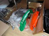 a box of carrots sitting on the floor next to a pile of boxes