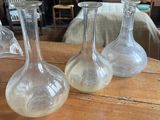 trois vases en verre transparent posés sur une table en bois