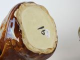 a brown vase with a number on it sitting on a table