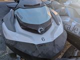 two jet skis parked on a trailer in a parking lot