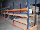 many shelves that are in a warehouse with orange shelves