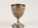 a silver cup that is sitting on a table