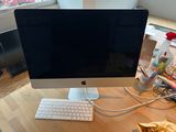 a computer on a desk with a keyboard and mouse