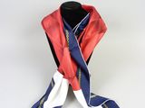 scarf on a mannequin stand with a red and blue scarf tied to it