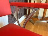 a red chair that is sitting in the corner of a room