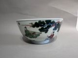 a white bowl with a design on it sitting on a table