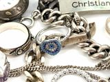 a lot of jewelry that is laying out on the table
