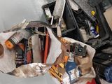 a bag full of tools on the floor of a garage