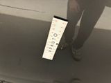 a person standing next to a ruler on the ground