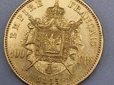 a close up of a gold coin with a coat of arms on it
