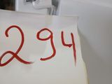 a sign with the number twenty on it in front of a refrigerator